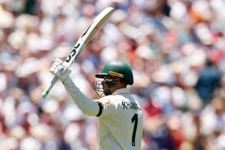 Usman Khawaja raises his bat after making fifty during day one of the third Ashes Test.
