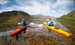 Two men kayaking in a loch, Scotland