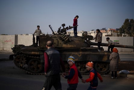 Children on the top of an ousted Syrian government forces tank