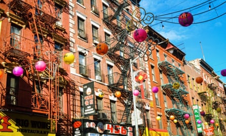 The installation of fuchsia, gold and flame-coloured lanterns on Mott Street.