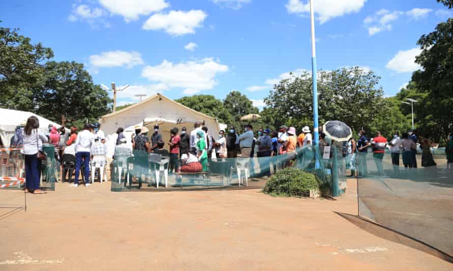 People queue to receive a coronavirus vaccine at Parirenyatwa Hospital on 31 March.