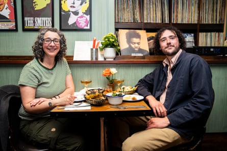 BJ and Toby smiling at the camera at a restaurant table