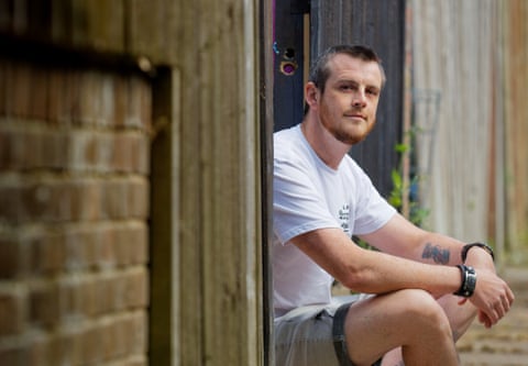 Portrait of him sitting next to a fence