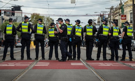 Police gather at an anti-lockdown protest in Melbourne