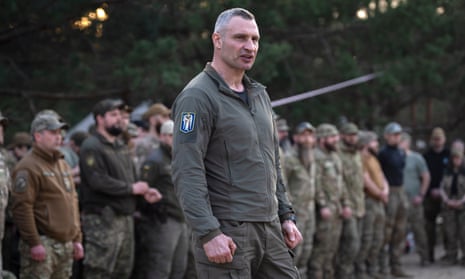 Vitali Klitschko stands before a line of Ukraine national guard servicemen. 