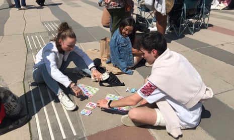 Fans play cards ahead of Taylor Swift's Paris show
