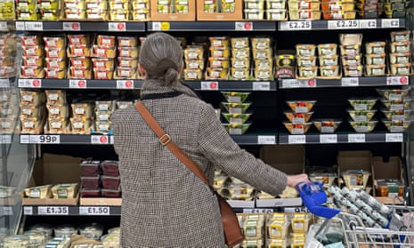 A customer shops for food items inside a supermarket in east London this month
