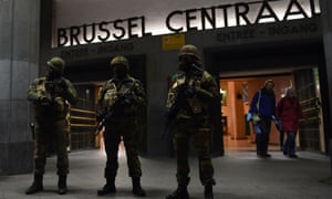 Soldiers stand guard in front of the central train station in Brussels on Sunday.