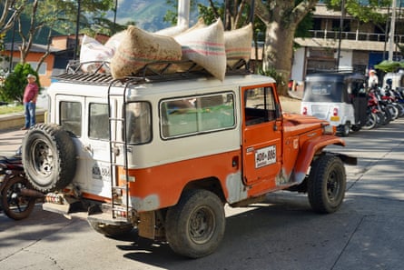 Sacks of coffee being transported on the roof of an ageing Toyota 4x4 in Betulia, Antioquia, Colombia.