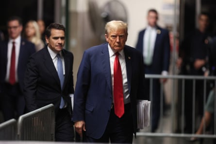 Donald Trump wears his trade-mark long red tie as he has his legal team arrive at court