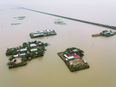 Aerial view of homes surrounded by flood water