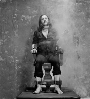 Strapped to an Electric Chair prop and smoking a cigarette during the photo session for the ‘Killed By Death’ single in 1984