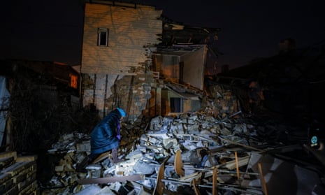 A local resident walks amid the debris of a private house destroyed during shelling in downtown Donetsk.