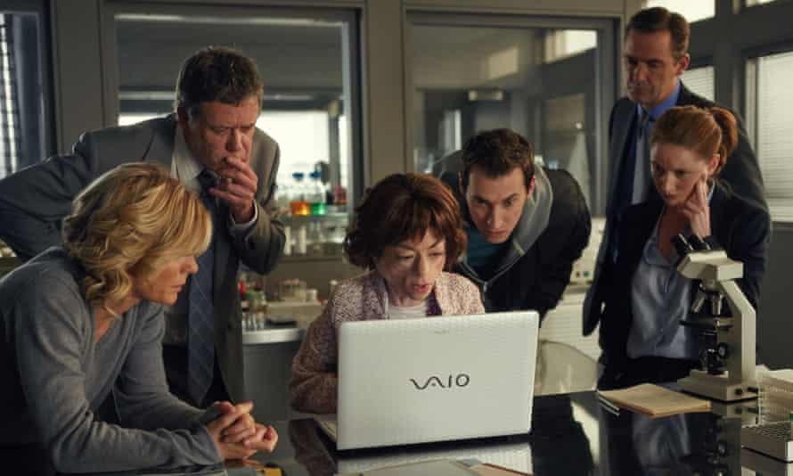Carr as Clarissa Mullery in Silent Witness, on a laptop surrounded by intent colleagues