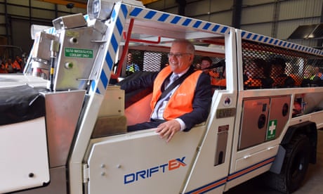 Prime Minister Scott Morrison inside an electric vehicle at an engineering facility specialising in renewable technology during a visit to the Hunter Valley on Monday