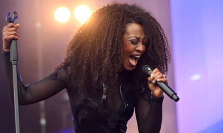 Beverley Knight on stage, singing powerfully into a microphone