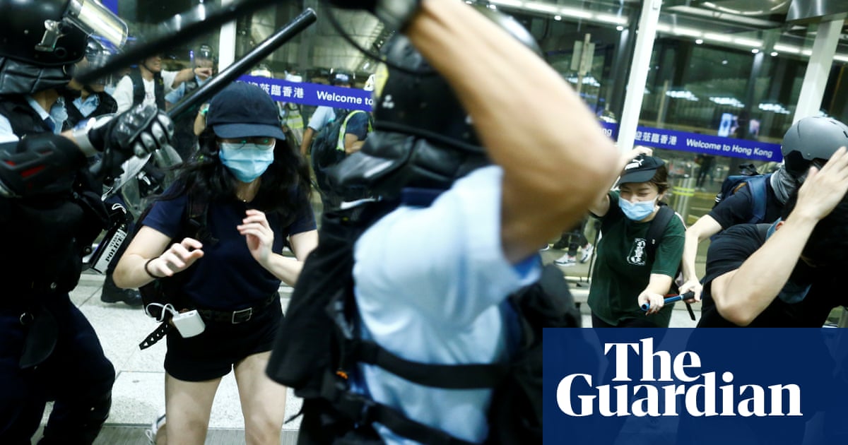 Hong Kong riot police clash with airport protesters