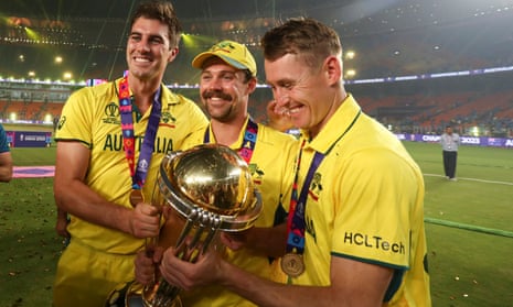 Pat Cummins (left) with Travis Head,  Marnus Labuschagne and the trophy