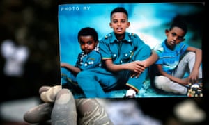 A rescue worker holds a photo of missing children following the fatal landslide at the Reppi rubbish dump on the outskirts of Addis Ababa