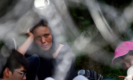 An Afghan family rest on the Serbian side of the border near Asotthalom.