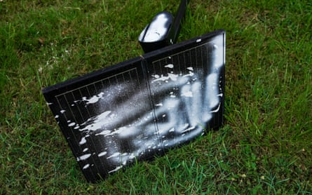 A spray-painted surveillance camera that has been cut down.