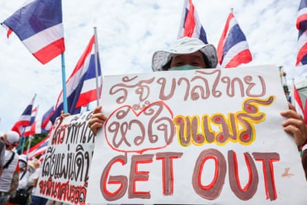 A royalist supporter holds a sign that reads "Thai government with Khmer heart Get Out" during an anti-government protest following the phone call leak.