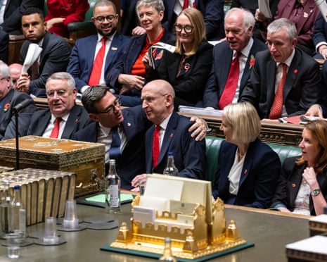 Prime Minister Andy Burnham hugs Chancellor John Healey after delivering his first annual budget