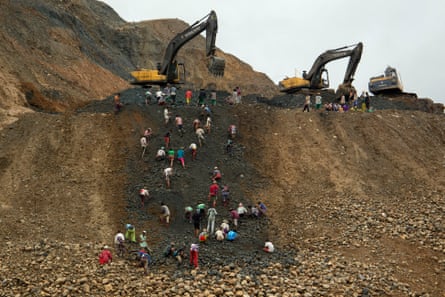 Freelance jade miners collect jade stones in an earth dump of a companies’ mining field in Hpakant area, Kachin State, Northern Myanmar.