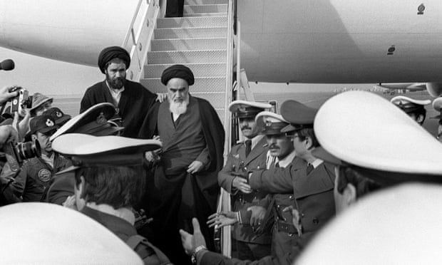 The Ayatollah Ruhollah Khomeini is welcomed at Tehran airport on 1 February 1979 on his return from exile in France.