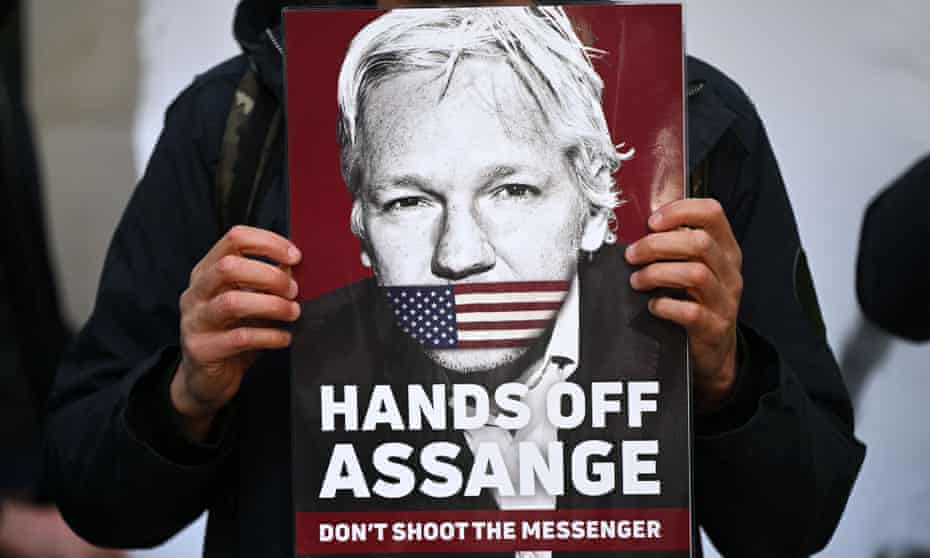 A supporter of Julian Assange holds a placard outside Westminster magistrates court