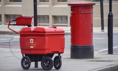 A Royal Mail post delivery cart parked next to a post box in central London