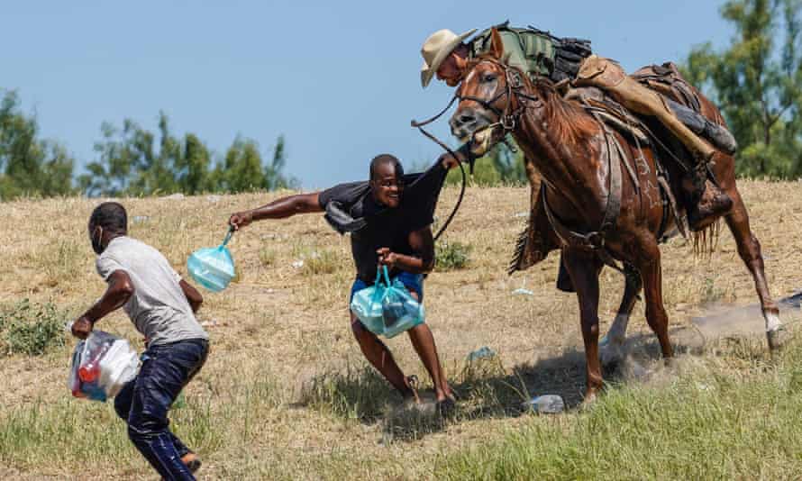 A United States border patrol agent on horseback tries to stop a Haitian migrant from entering an encampment on the banks of the Rio Grande near the international bridge in Del Rio, Texas, on Sunday.