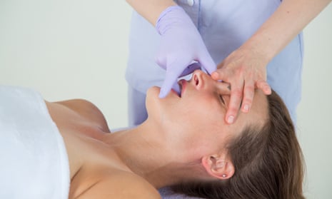 A woman receiving a buccal massage