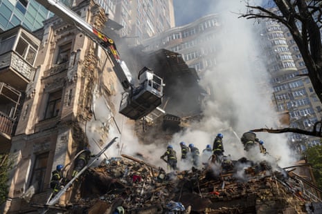 Firefighters work after a drone attack on buildings in Kyiv.
