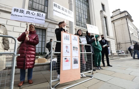 A group of protesters stand opposite the Chinese Embassy in London, England