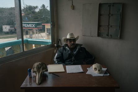Enrique Aran Blanco, president for more than 20 years of the fishermen co-operative of Saladero, sits in his office in front of a sword that was given symbolically by a lawyer working along them against BP, and beside skulls of a dolphin and a tortoise found dead at the beach about five years after the oil spill.
