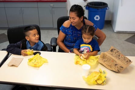 Sara Vasquez Gonzalez, 45, of Chiapas, Mexico, eats with her children at Casa Alitas in Tucson, Arizona, on 15 March.