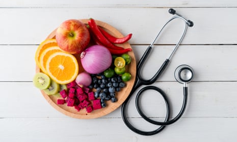 Bowl of fruit and vegetables and doctor's stethoscope
