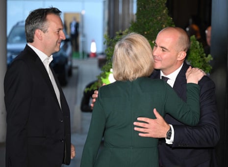 Jake Berry (right) welcoming Liz Truss to the Tory conference last night, as Truss arrived with her husband, Hugh O'Leary.