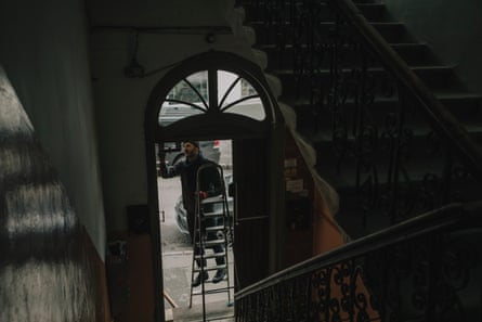 A man repairing a door frame of a house in Kyiv.