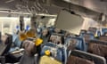 Oxygen masks and panels hang from the plane's ceiling