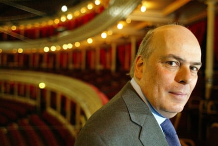 Raymond Gubbay, impresario, sits in a theatre with ornate balconies and lights behind