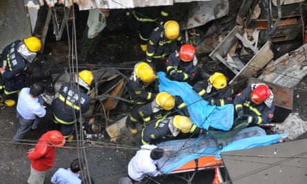 Firefighters carry out the body of a victim after an explosion in a restaurant in Wuhu, China