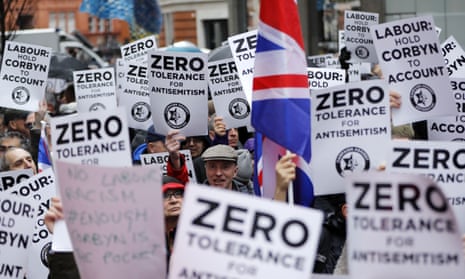 Protesters carry signs reading 'Labour: hold Corbyn to account' and 'Zero tolerance for antisemitism'
