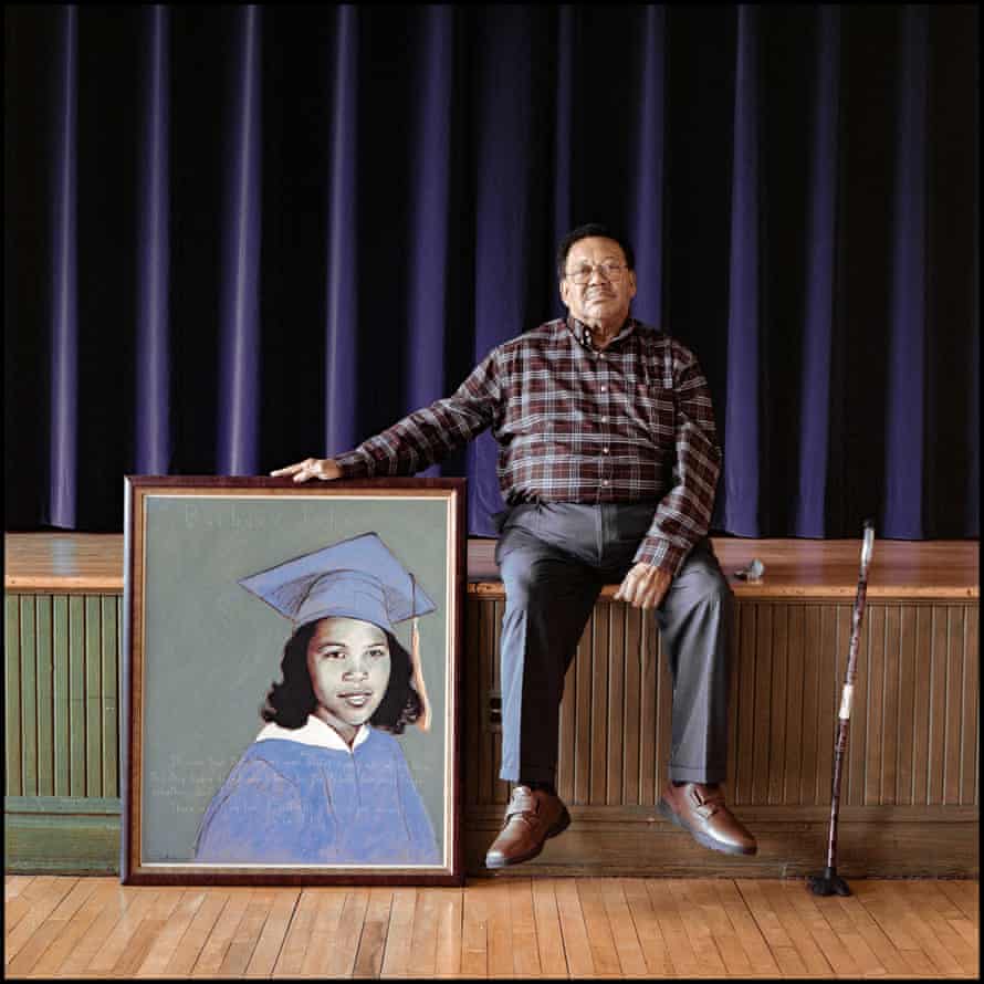 Robert Hamlin Sr, a former student at Robert Russa Moton high school, with a portrait of Barbara Johns, on the stage where Johns gave her initial strike speech to students.