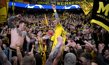 Marco Reus celebrates with Dortmund fans in the away section at Parc des Princes