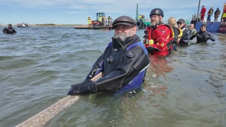 Rescuers work to help Timmy the whale into the barge in Poel, Germany.