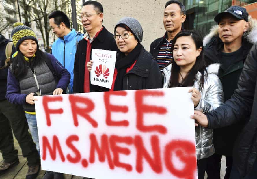 People hold a sign at a Vancouver courthouse prior to Meng’s bail hearing in December 2018.