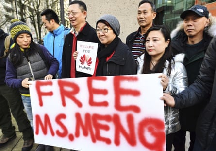 People hold a sign at a Vancouver courthouse prior to Meng’s bail hearing in December 2018.