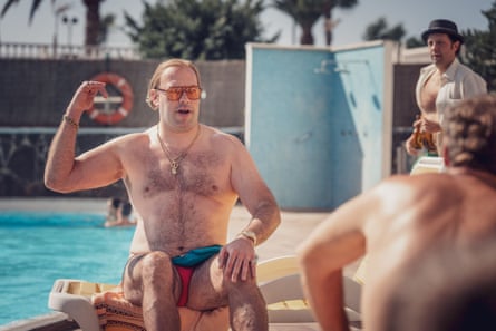 Tom Davis as Big Mick wearing tight swimming trunks in The Curse.